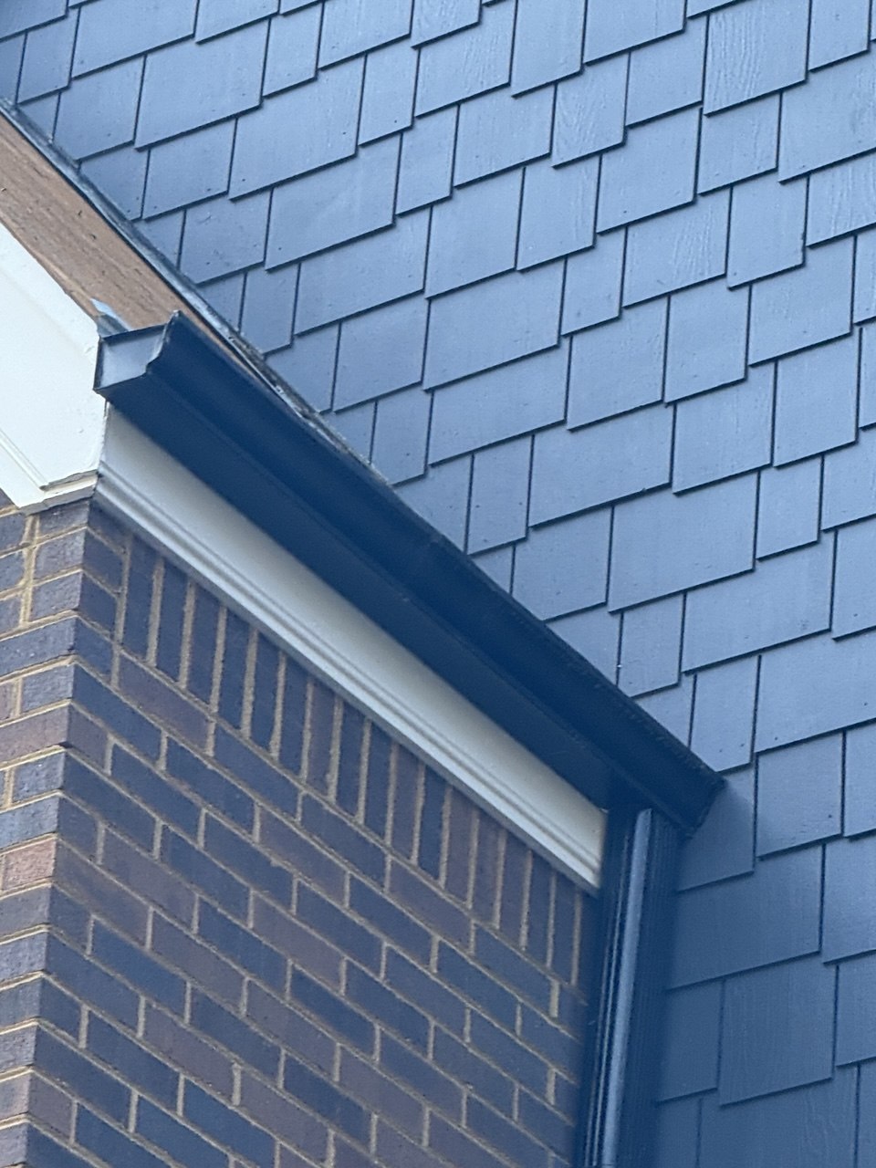 New seamless gutter installation on Atlanta home with shake siding