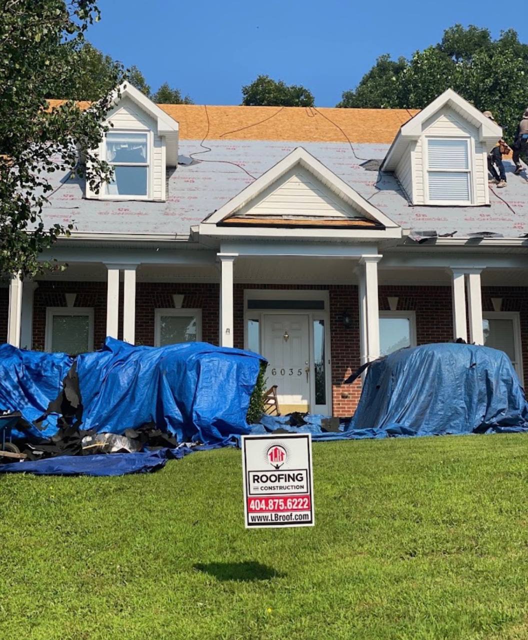 LB Roofing yard sign and roof tear-off in progress Atlanta