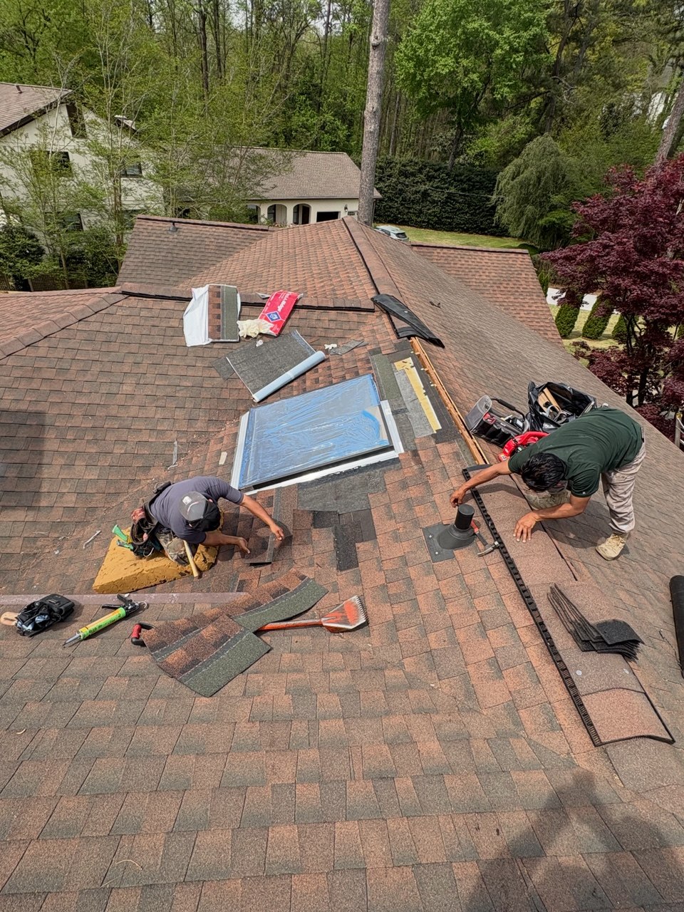LB Roofing crew repairing skylight and shingles on Atlanta home